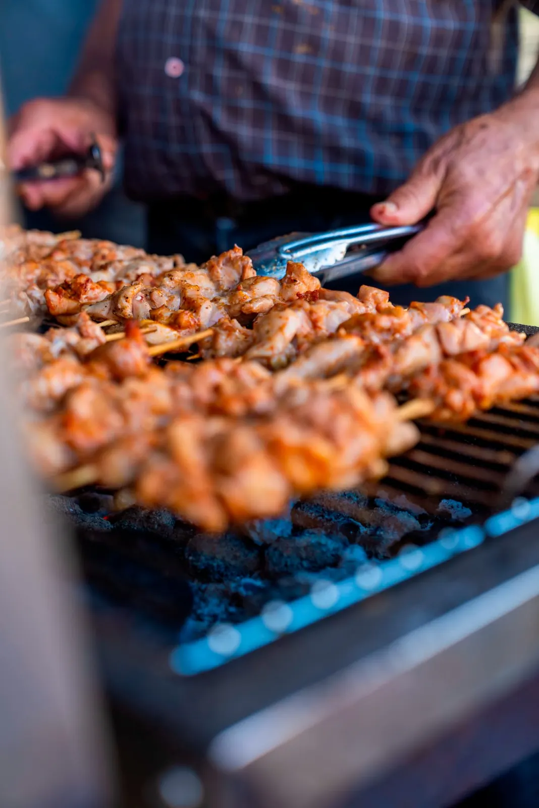 Marinated chicken skewers cooked over glowing charcoal
